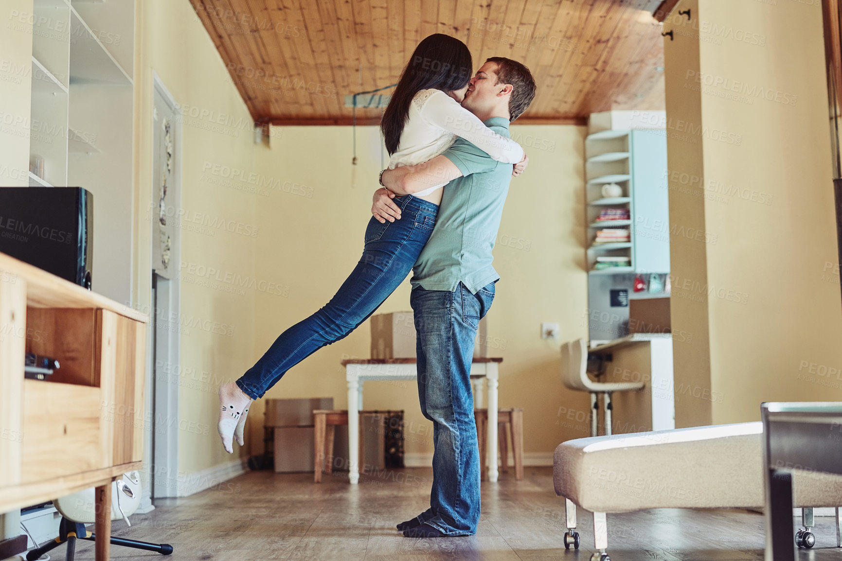 Buy stock photo Happy couple, care and kiss with hug, bonding and together for anniversary or celebration in home. Married people, embrace and affection as partner in relationship for support, trust or love in house