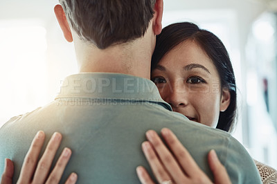 Buy stock photo Cropped shot of an affectionate couple embracing each other at home
