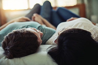 Buy stock photo Shot of a happy couple laying in bed