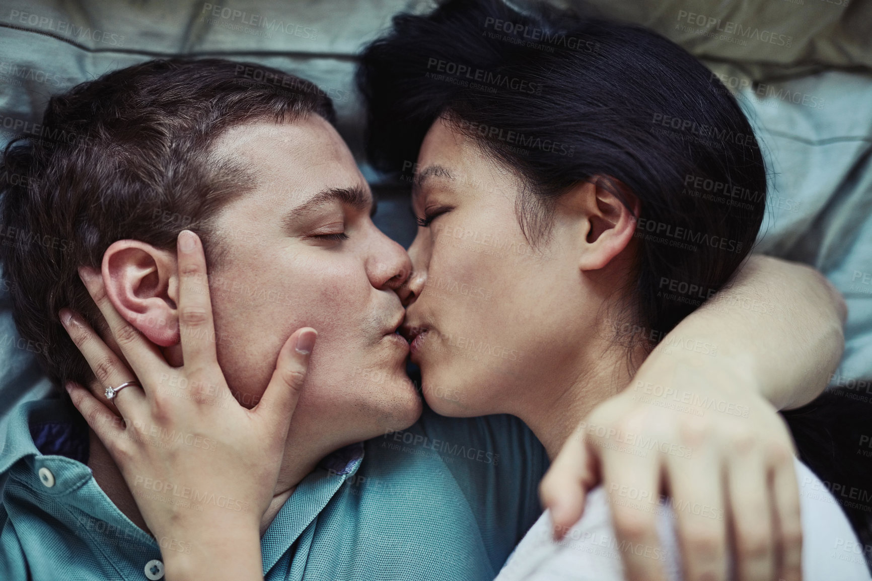 Buy stock photo Cropped shot of a loving young couple relaxing at home