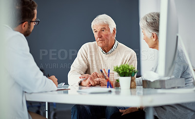 Buy stock photo Shot of a senior couple having a consultation with a doctor in a clinic