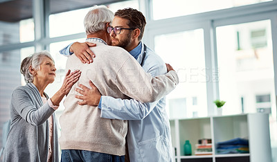 Buy stock photo Shot of a doctor comforting a senior couple in a clinic