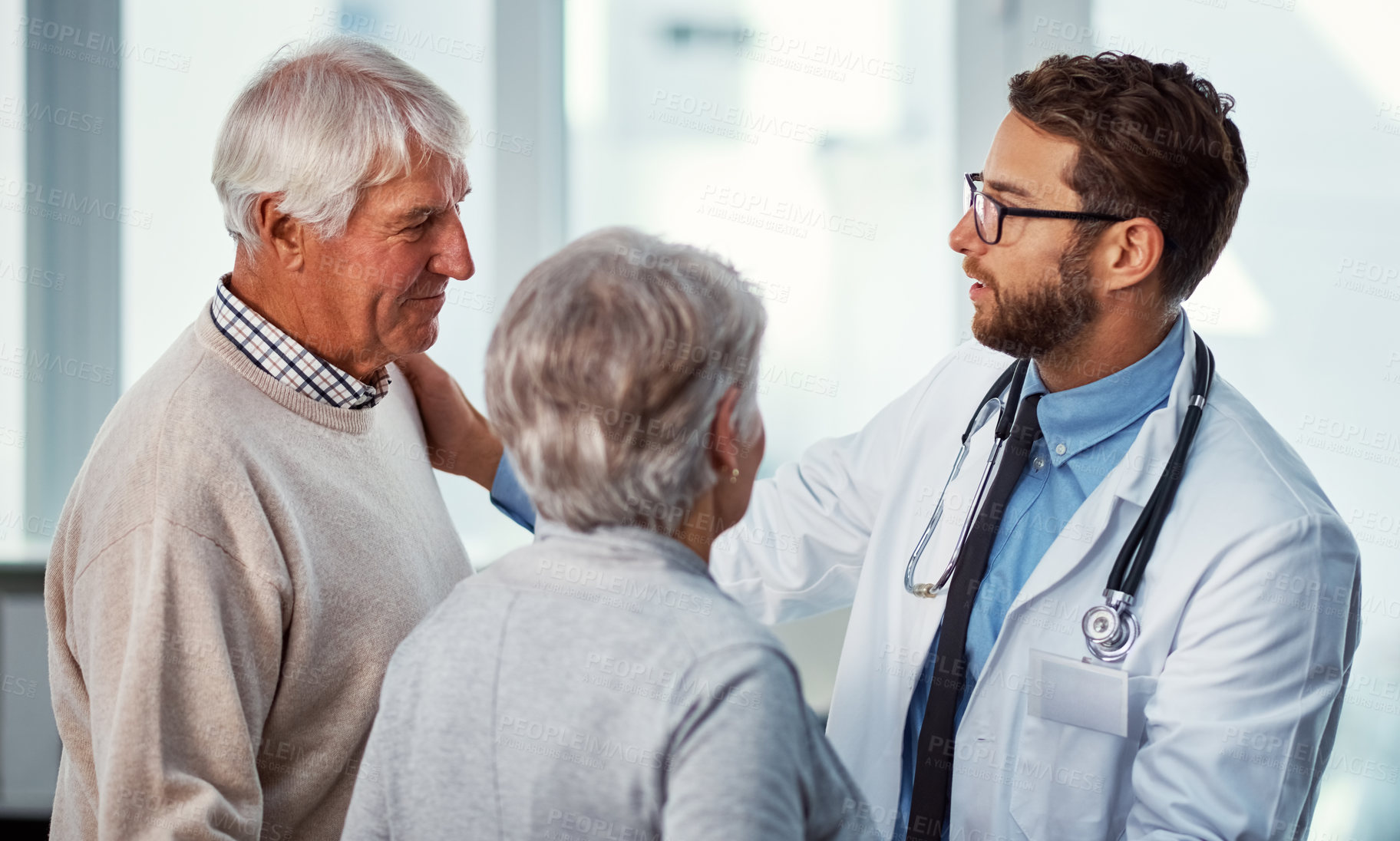 Buy stock photo Talking, hospital and doctor with senior couple for support, compassion or empathy for diagnosis. Healthcare, clinic and elderly man and woman for consulting, medical results or feedback for wellness