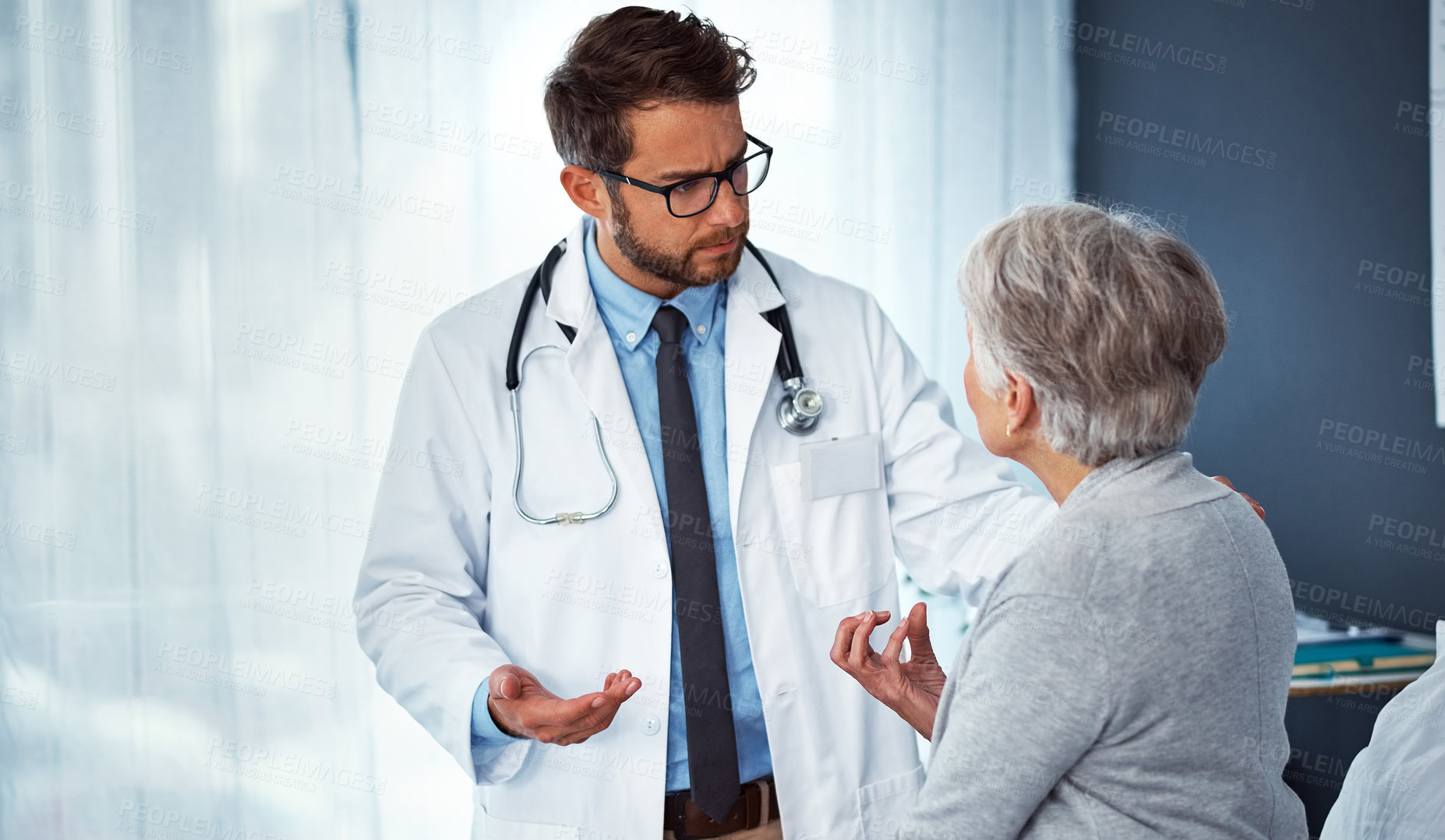 Buy stock photo Shot of a doctor examining a senior patient in a clinic