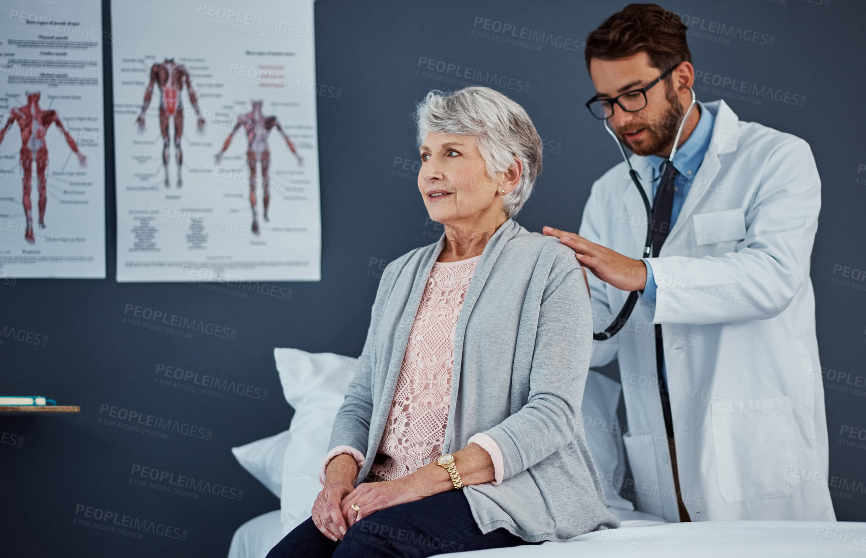 Buy stock photo Shot of a doctor examining a senior patient with a stethoscope in a clinic