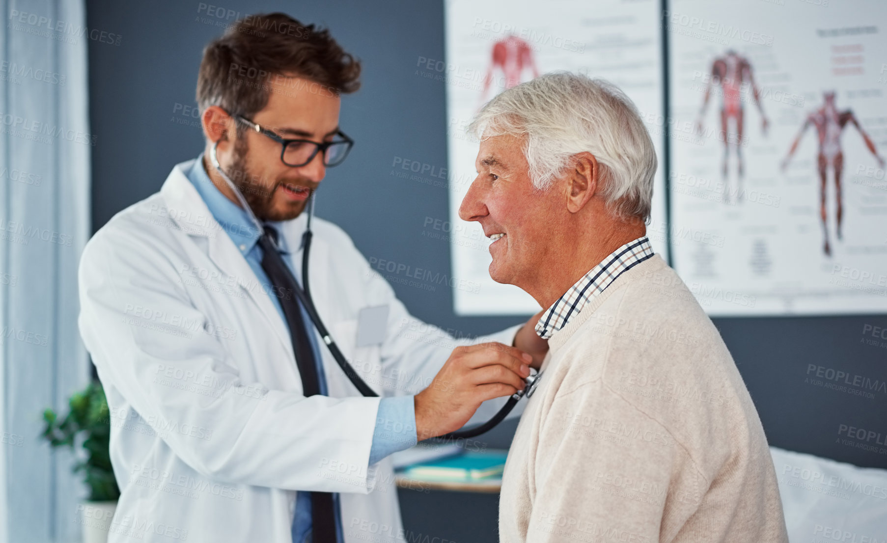 Buy stock photo Shot of a doctor examining a senior patient with a stethoscope in a clinic