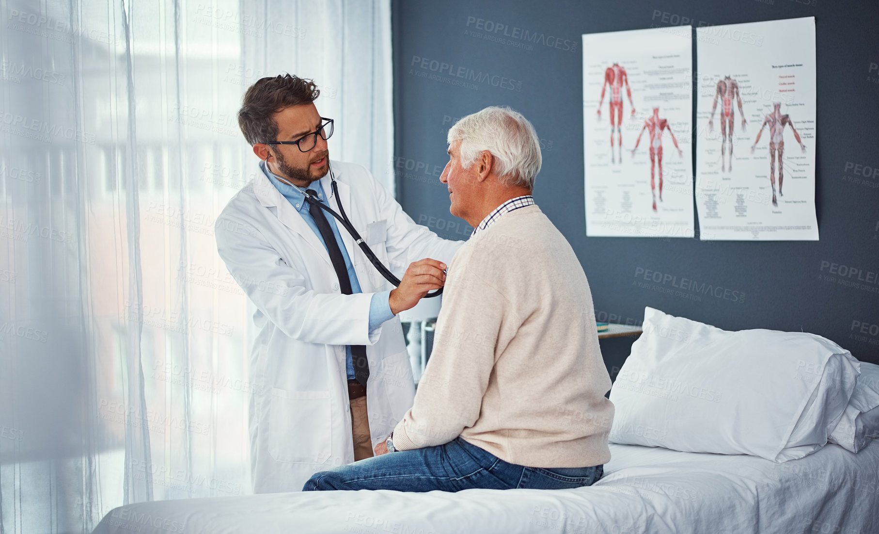 Buy stock photo Shot of a doctor examining a senior patient with a stethoscope in a clinic