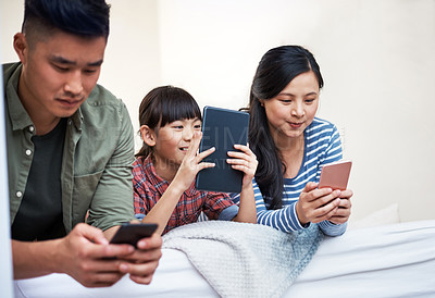 Buy stock photo Shot of a family using digital devices at home