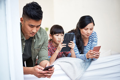 Buy stock photo Shot of a family using digital devices at home