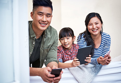 Buy stock photo Portrait of a family using digital devices at home