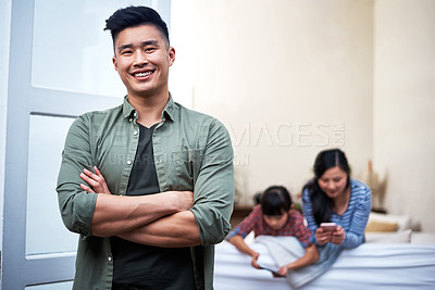 Buy stock photo Portrait of a young man relaxing with his family at home