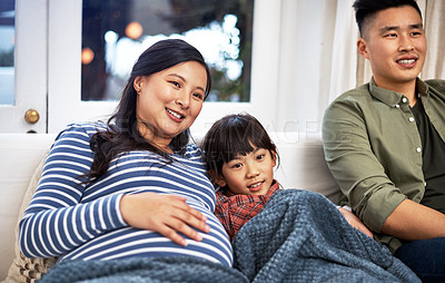 Buy stock photo Shot of a family watching television together at home