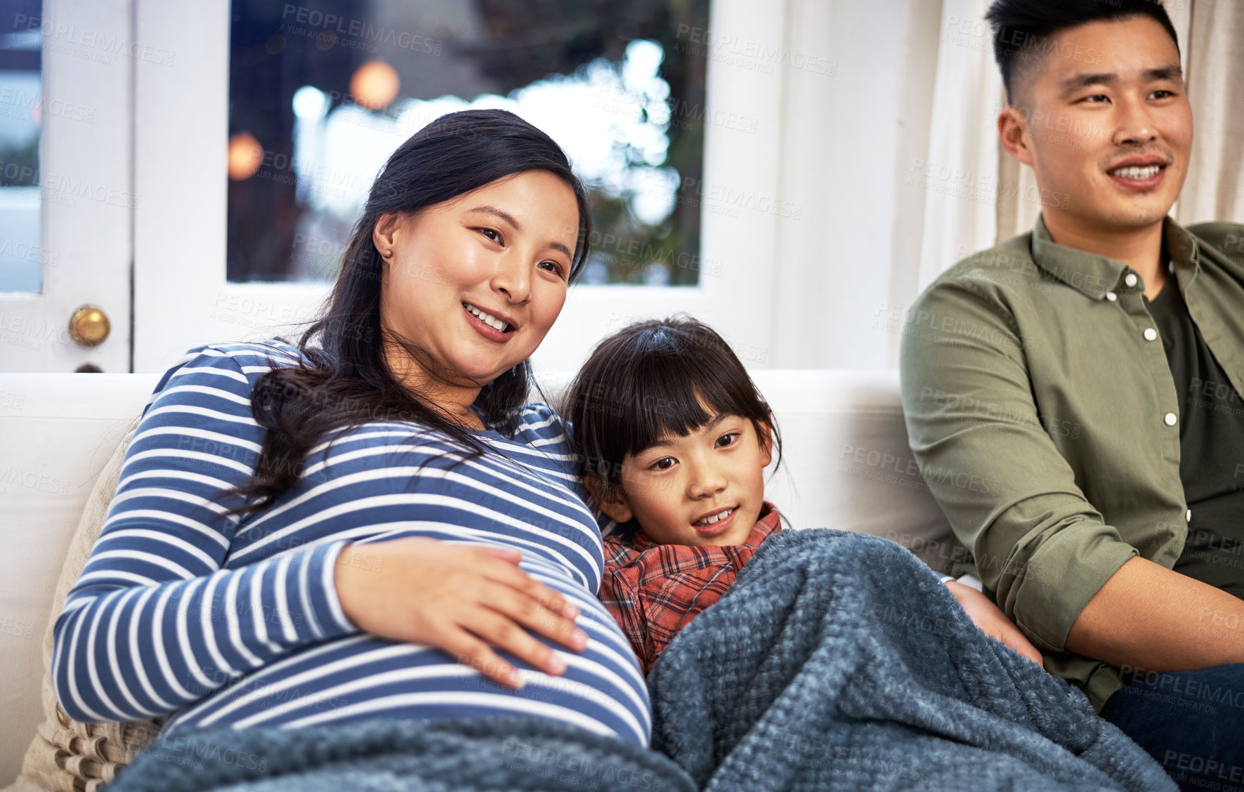 Buy stock photo Shot of a family watching television together at home