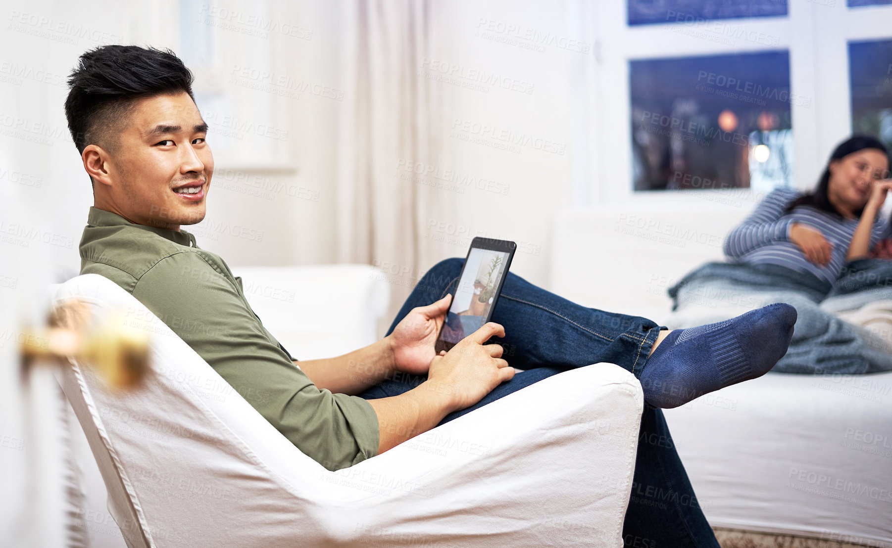 Buy stock photo Man, tablet and relax on sofa at family home with smile for renovation project, search or online inspiration. Asian person, happy and tech with interior design app, portrait or screen at apartment