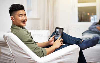 Buy stock photo Portrait of a man using a digital tablet with his family in the background