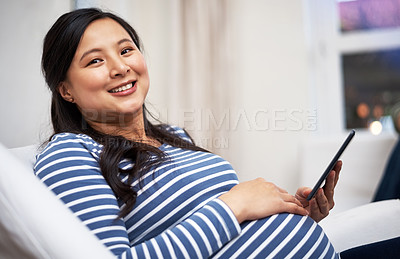Buy stock photo Portrait of a pregnant woman using a digital tablet at home