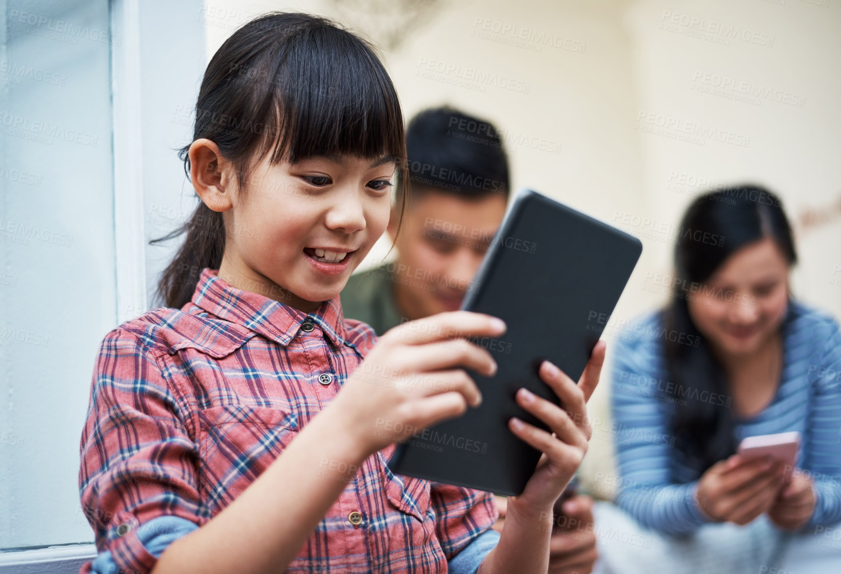 Buy stock photo Home, parents or girl with tablet, funny or digital app for social media, internet or smile. Asian family, watching video or people with daughter, tech or connection with games or online humor