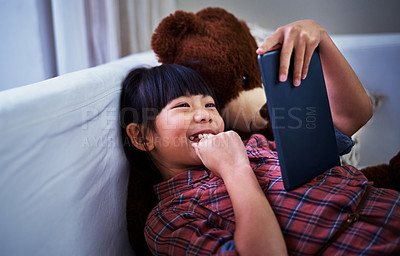Buy stock photo Shot of a little girl using a digital tablet at home