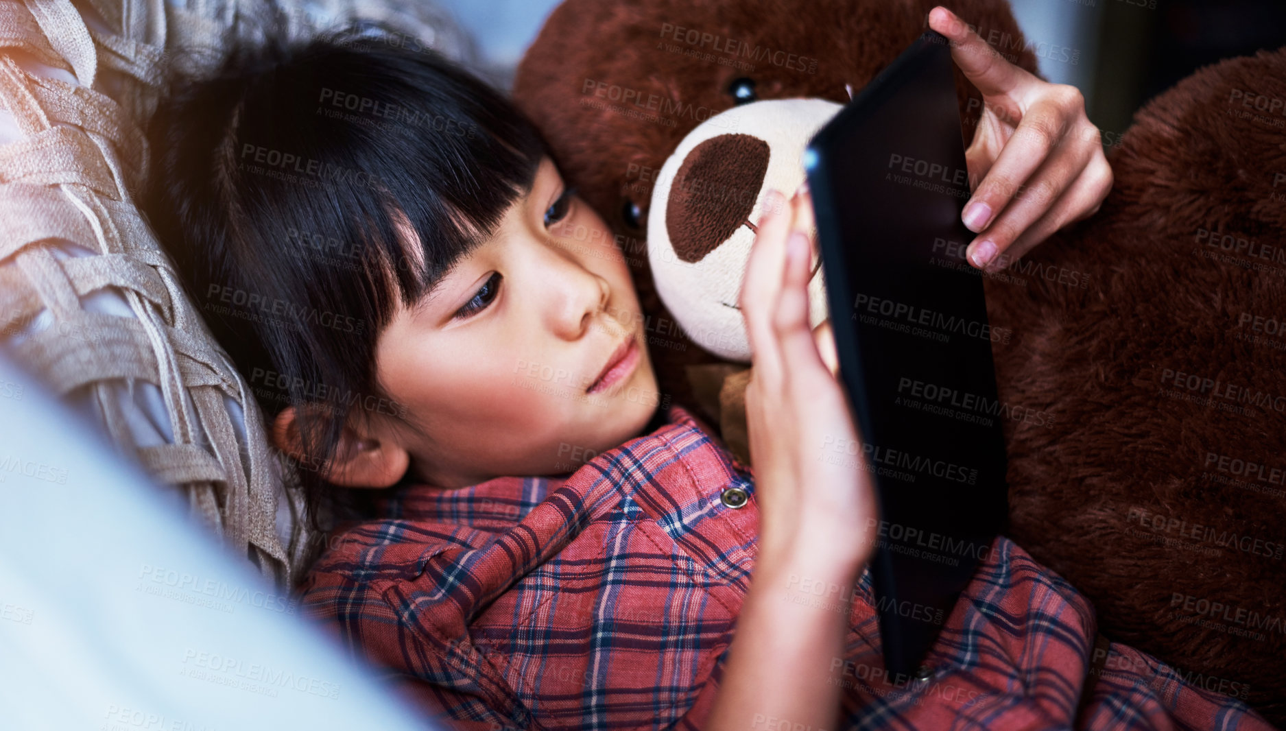 Buy stock photo Shot of a little girl using a digital tablet at home
