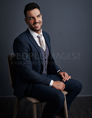 Buy stock photo Studio shot of a stylish young businessman looking thoughtful against a gray background