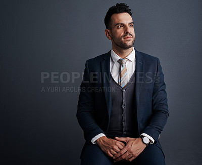 Buy stock photo Studio shot of a stylish young businessman looking thoughtful against a gray background