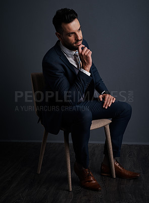 Buy stock photo Studio shot of a stylish young businessman looking thoughtful against a gray background