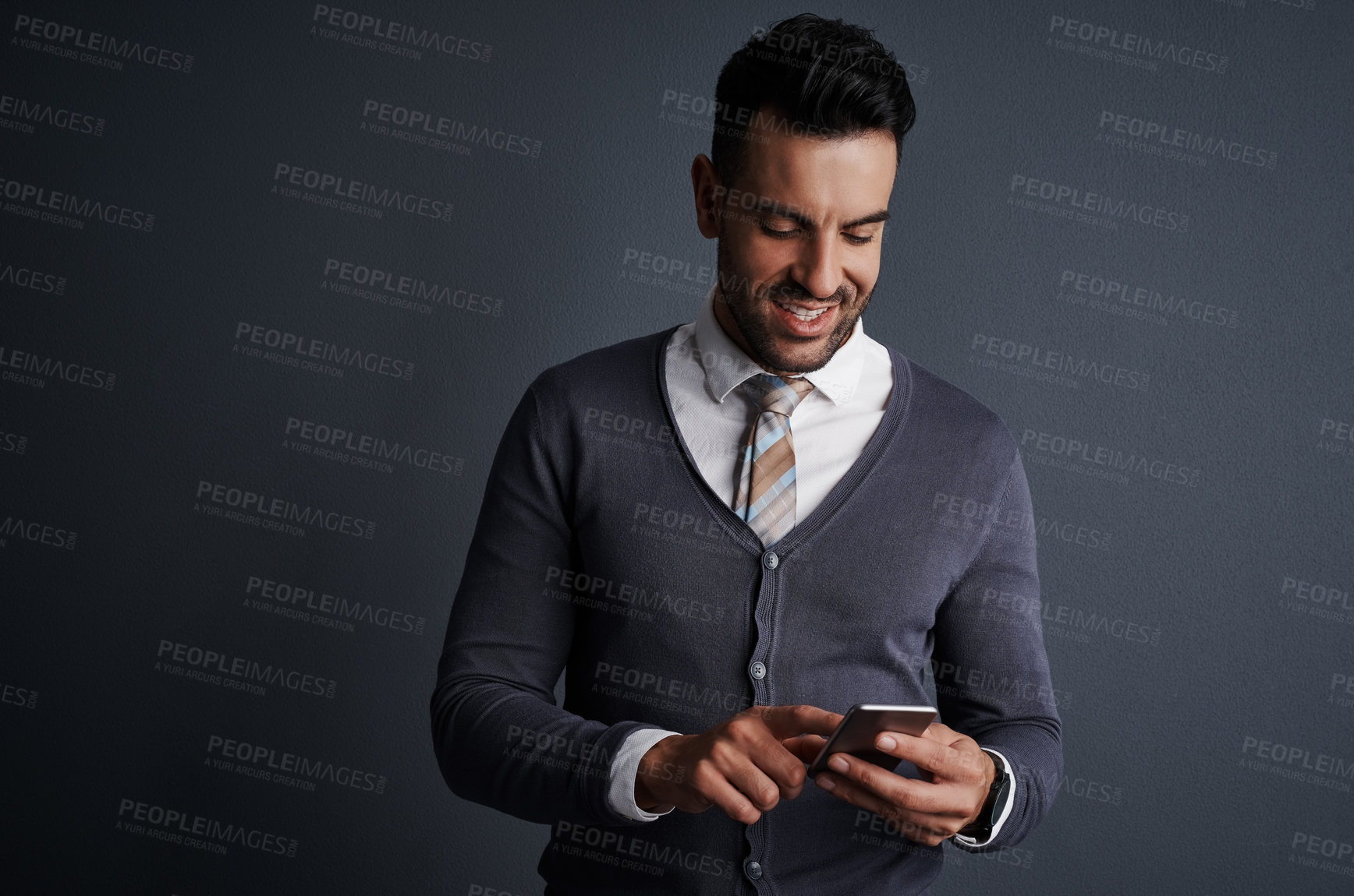 Buy stock photo Happy, typing and businessman with smartphone, studio or networking with contact on social media app. Employee, scroll and person with mobile for message on website, gray background and space