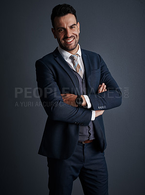 Buy stock photo Studio shot of a stylish and confident young businessman posing against a gray background