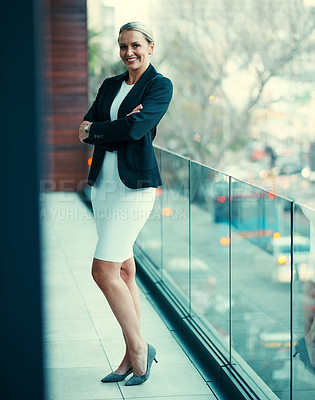 Buy stock photo Portrait of a mature businesswoman standing outside on the balcony of her corporate office