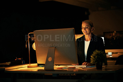 Buy stock photo Shot of a mature businesswoman working late at the office