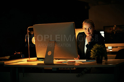Buy stock photo Shot of a mature businesswoman working late at the office 