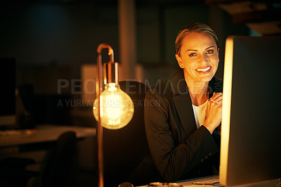 Buy stock photo Shot of a mature businesswoman working late at the office 