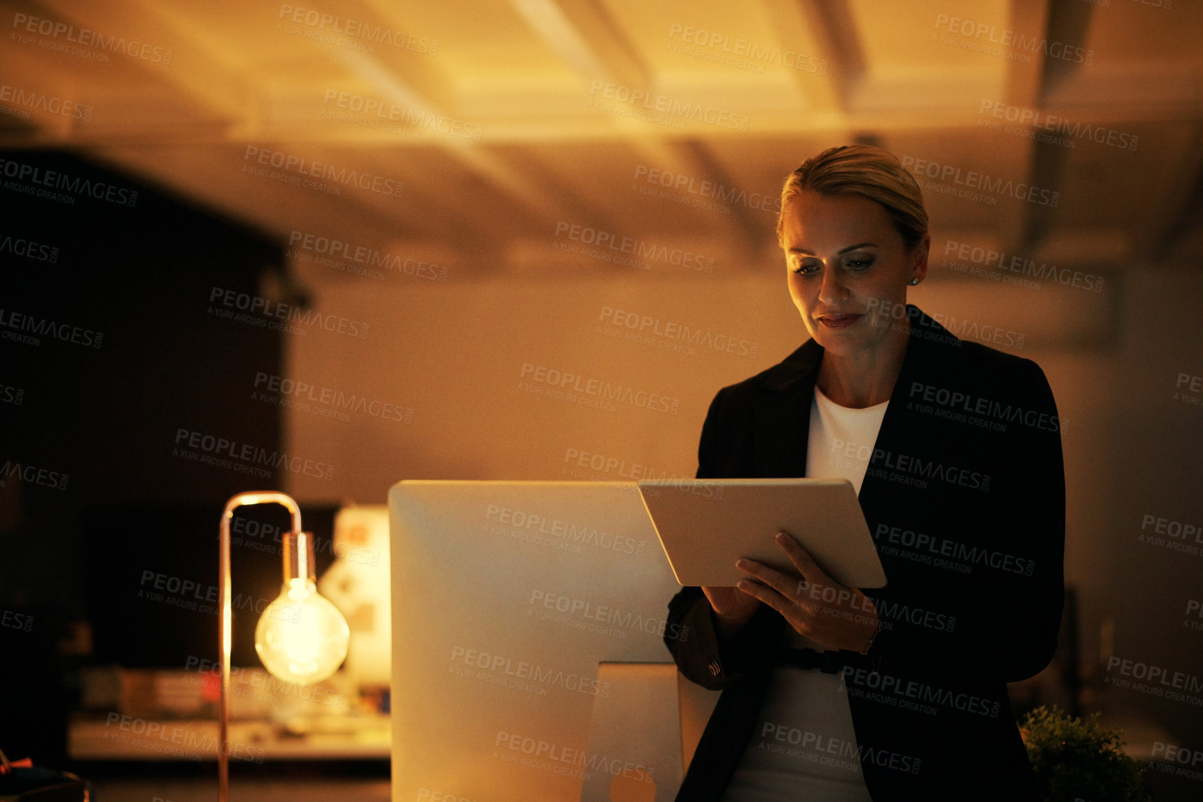 Buy stock photo Night, woman and reading in office with tablet, news report deadline and investigation for journalism. Late, mature person and research in workplace with tech, review or fact check story for website.