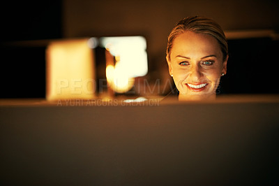 Buy stock photo Shot of a mature businesswoman working late at the office 