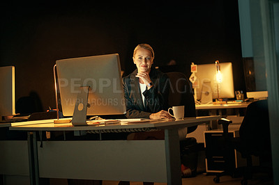 Buy stock photo Shot of a mature businesswoman working late at the office 
