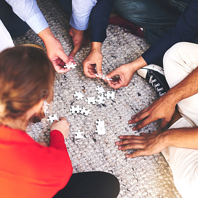Buy stock photo Business, people and group with puzzle on floor for team building, common goal and problem solving in workplace. Top view, hands and collaboration for concentration skills, synergy and creativity