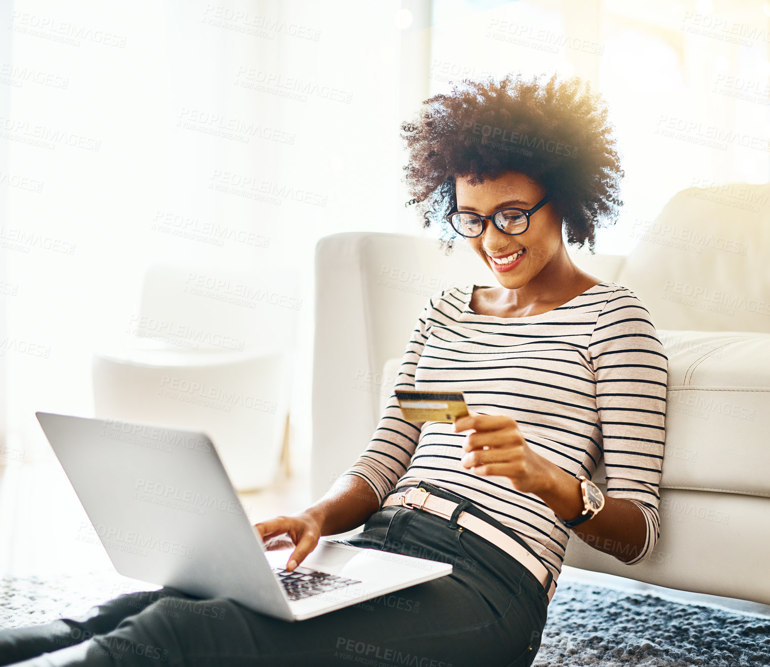 Buy stock photo Happy woman, laptop and credit card in house for online shopping payment sitting on ground or carpet. Girl, smile and African female person buying on ecommerce app website reading deal news in home
