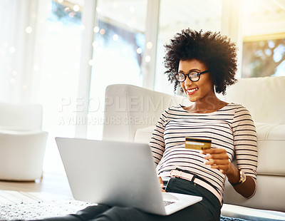 Buy stock photo Young woman, laptop and credit card in living room doing online shopping sitting on ground. Home, happiness and computer of African female person on a internet ecommerce app reading online deal