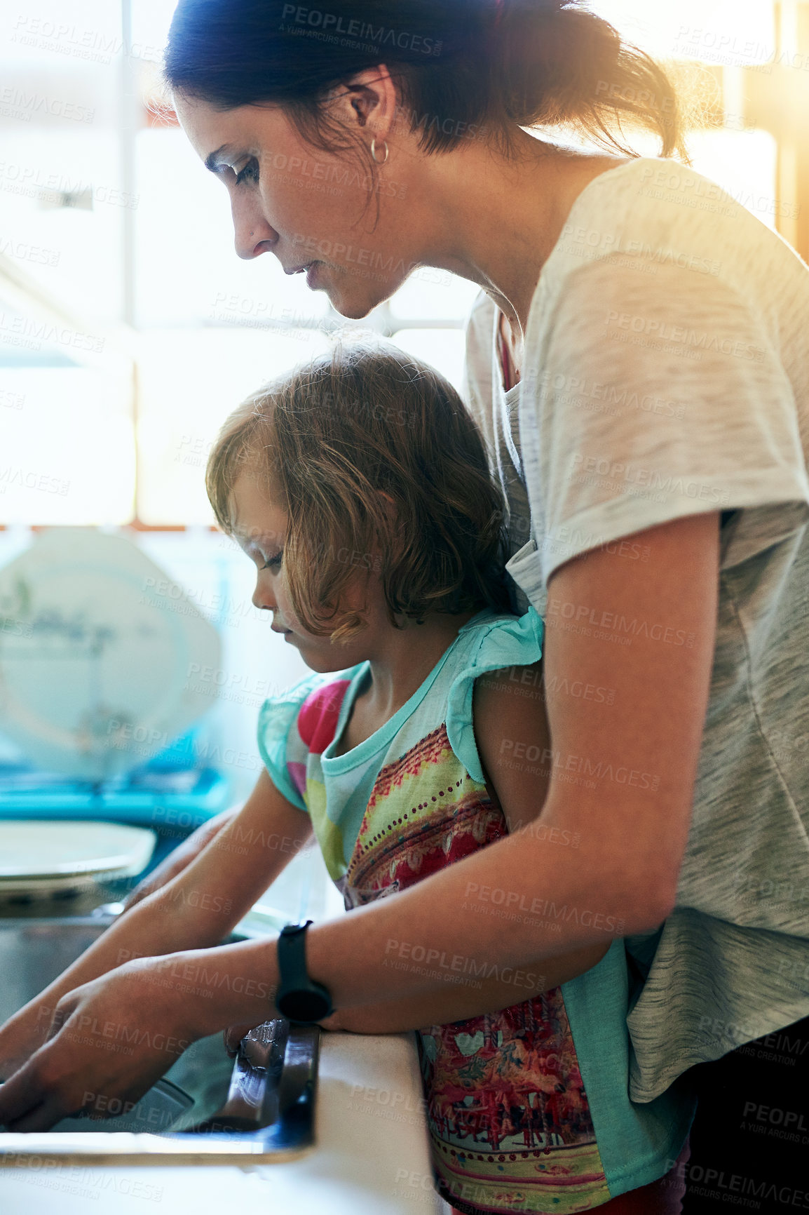 Buy stock photo Washing, dishes and mom with girl, help and teaching chores, learning hygiene and routine in home. Housekeeping, mother and daughter cleaning kitchen together in support, care and child development