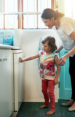 Buy stock photo Help, dishwasher and mother with daughter in home for chores, teaching or learning hygiene routine. Housekeeping, mom and girl cleaning kitchen together with support, machine and child development