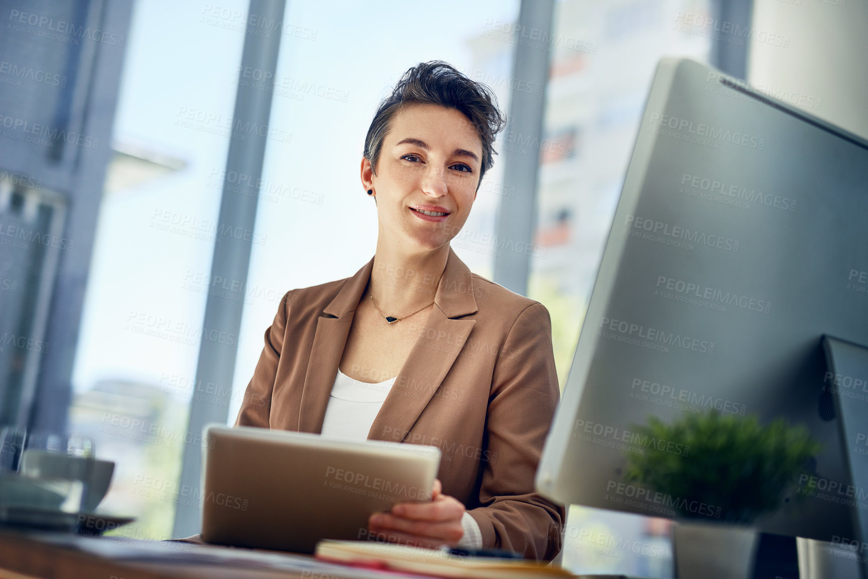 Buy stock photo Portrait of a businesswoman working on a digital tablet in an office