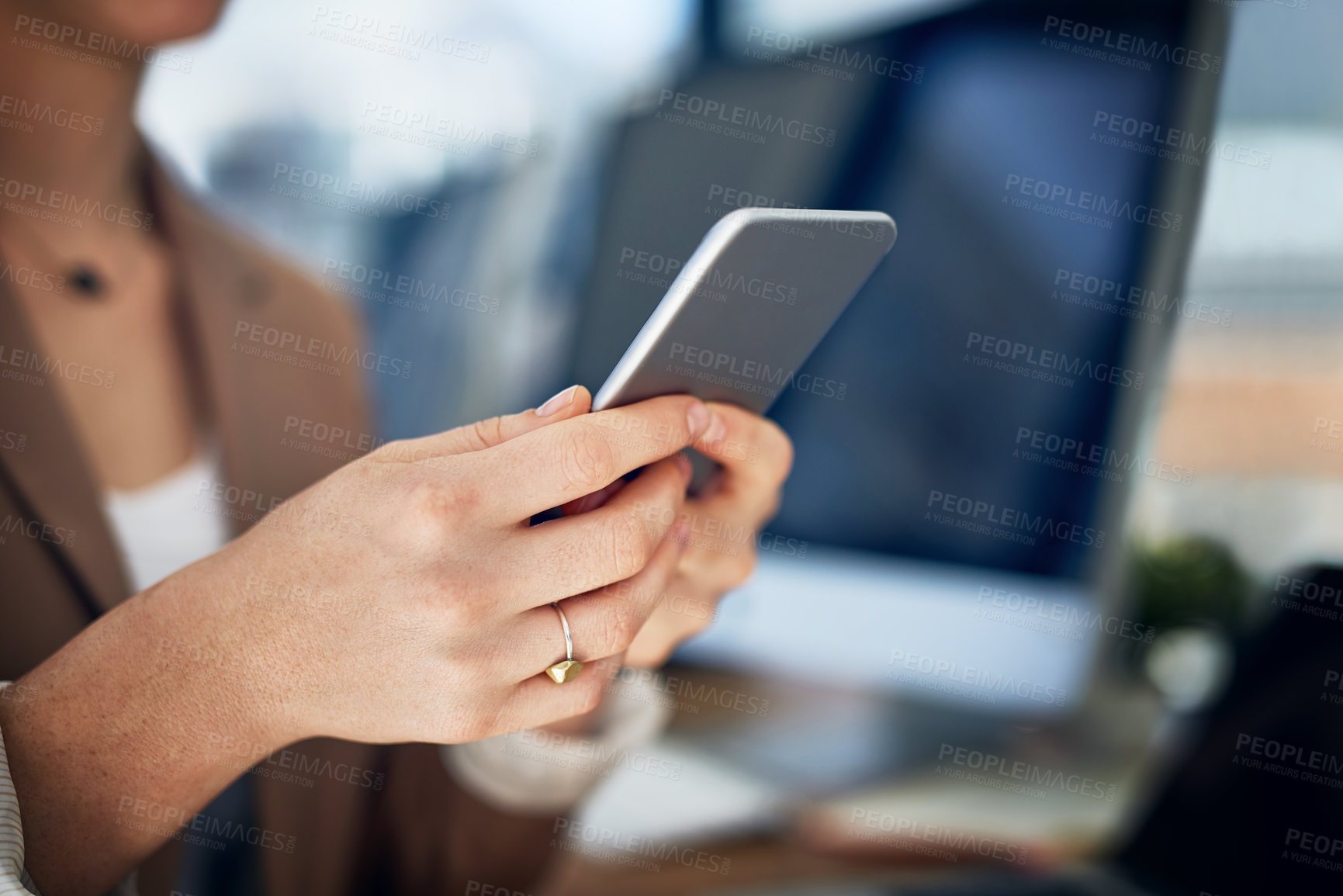 Buy stock photo Closeup shot of an unrecognizable businesswoman using her cellphone in an office