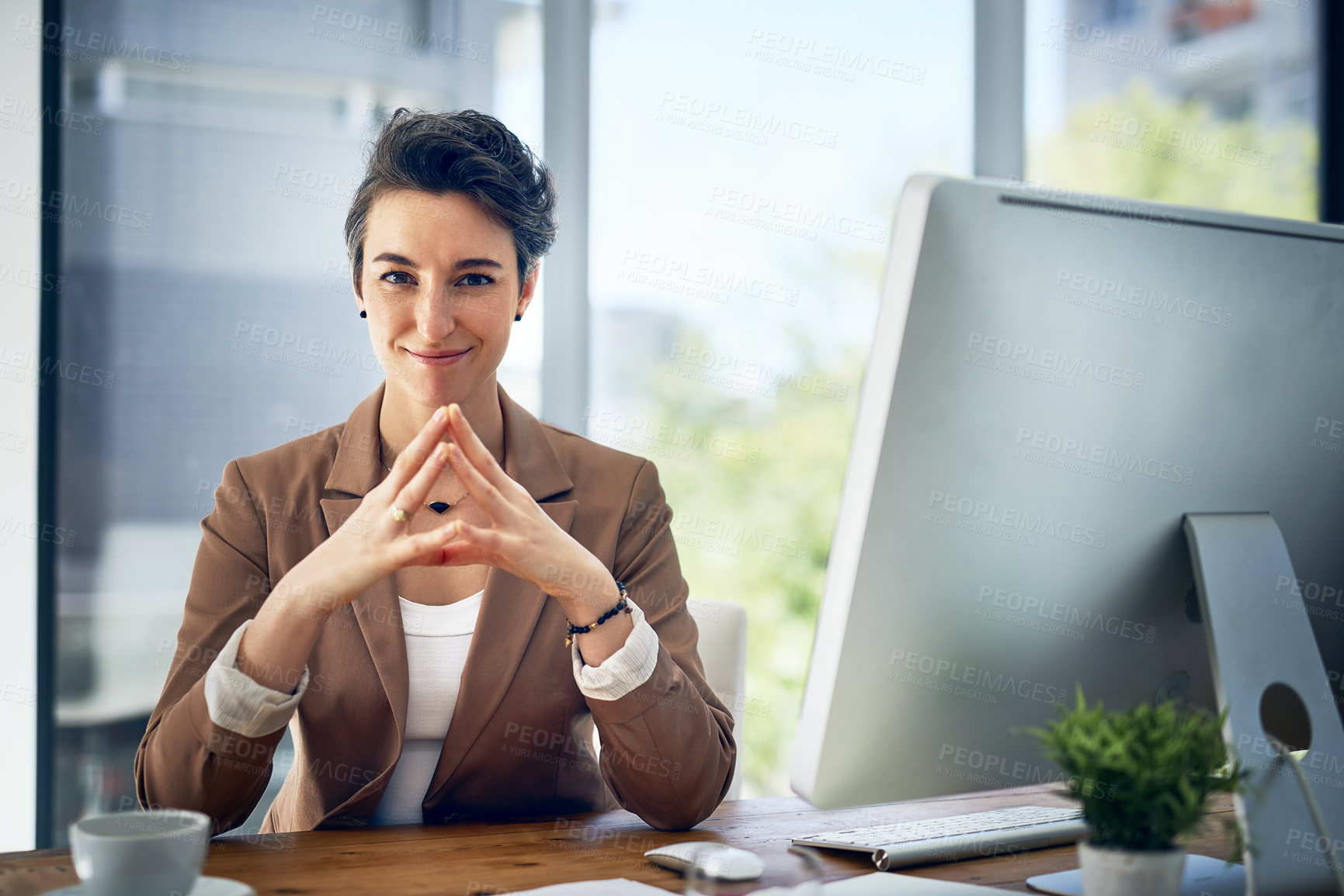 Buy stock photo Portrait of a businesswoman working at her desk in an office