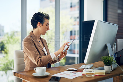 Buy stock photo Shot of a businesswoman working on a digital tablet in an office