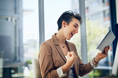 Buy stock photo Shot of a businesswoman doing a fist pump while working on a digital tablet in an office