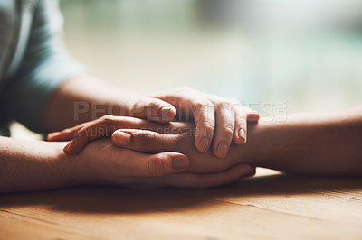 Buy stock photo Love, empathy and support with people holding hands in comfort, care or understanding on a wooden table of a home. Prayer, faith or depression with friends closeup for hep, hope or peace for healing