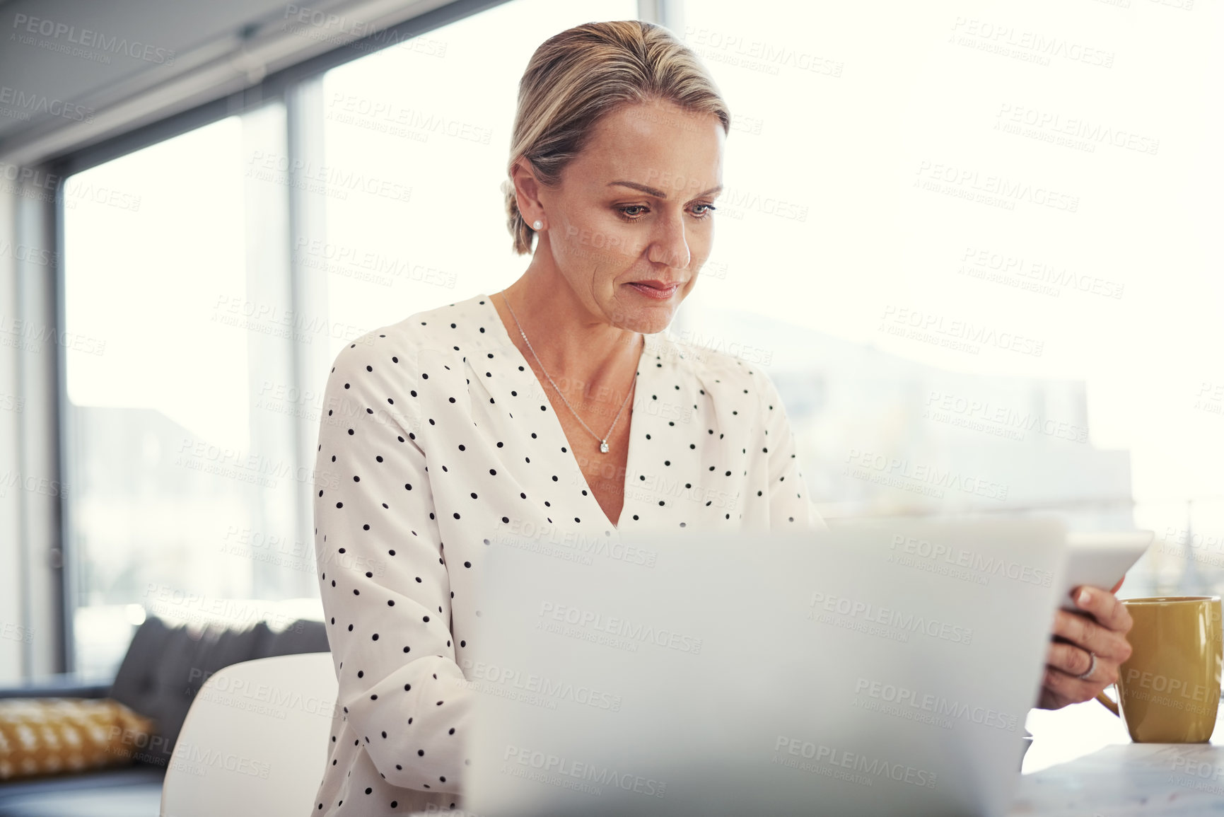 Buy stock photo Cropped shot of a mature businesswoman working from her home office