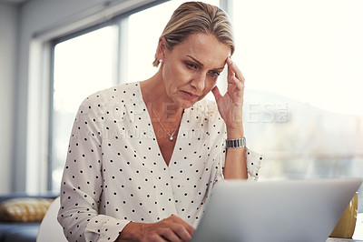 Buy stock photo Cropped shot of a mature businesswoman working from her home office