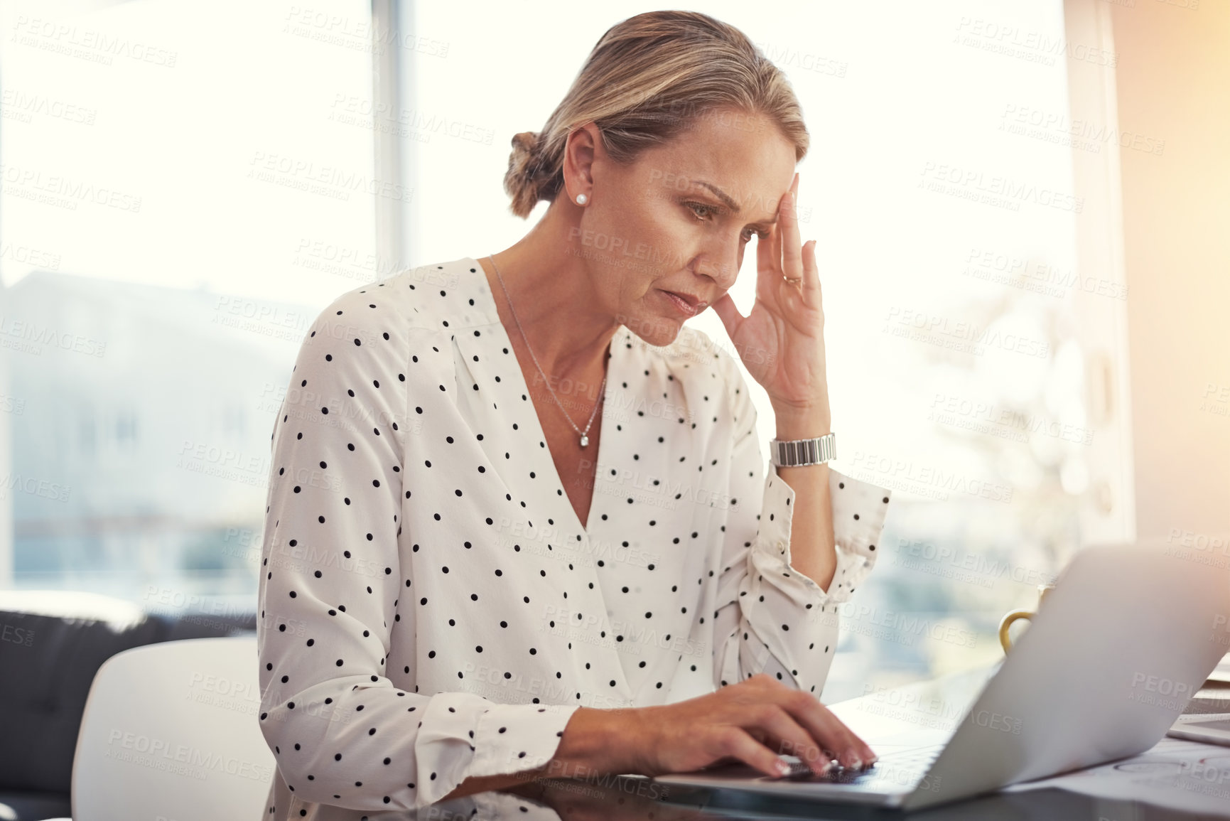 Buy stock photo Cropped shot of a mature businesswoman working from her home office