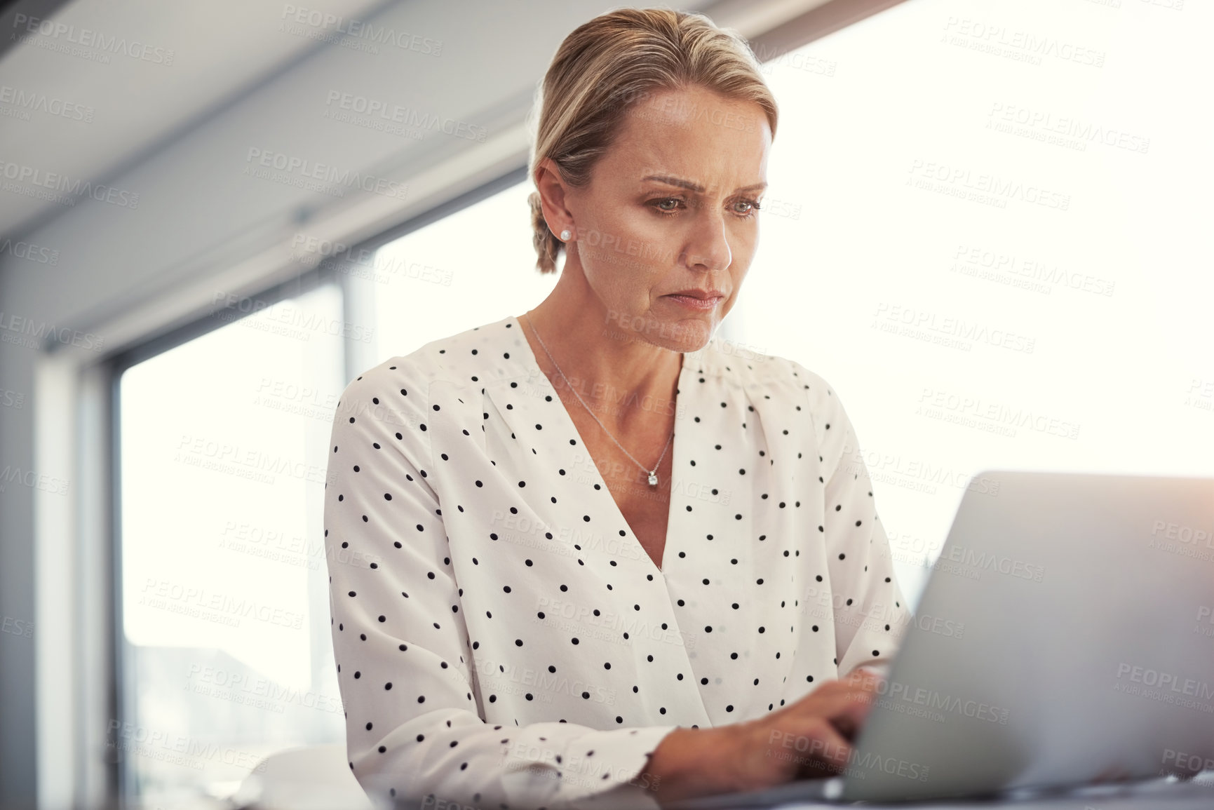 Buy stock photo Cropped shot of a mature businesswoman working from her home office